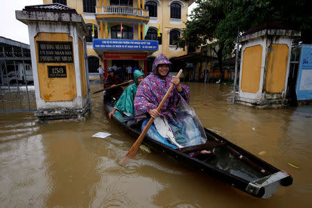 Officials sail a boat out of a submerged local government building after typhoon Damrey hits Vietnam in Hue city, Vietnam November 5, 2017. REUTERS/Kham