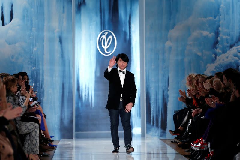 FILE PHOTO: Russian designer Valentin Yudashkin greets the audience after his Fall-Winter 2013/2014 women's ready-to-wear fashion show during Paris fashion week