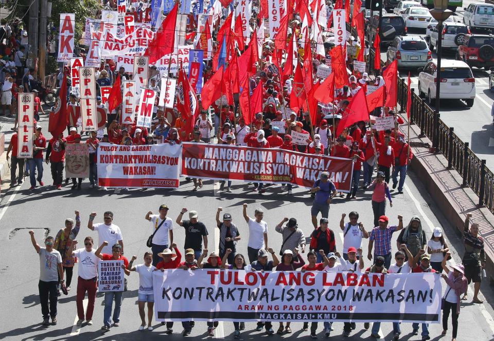 <p>Protesters, mostly workers march towards the Presidential Palace during the global commemoration of Labor Day, May 1, 2018 in Manila, Philippines. About 5,000 workers and activists from various groups held a rally Tuesday near the Malacanang Palace to protest the failure of Philippine President Rodrigo Duterte to fulfill a major campaign promise to end contractualization, the widespread practice of short-term employment. (Photo: Bullit Marquez/AP) </p>
