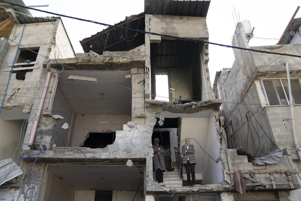 Mourners follow the funeral of killed Palestinians from their patly destroyed house in the West Bank refugee camp of Tulkarem, Friday, Jan. 19, 2024. The Israeli army withdrew early morning from the Tulkarem refugee camp after a 45 hours wide military operation in the refugee camp, the Israeli army said. Eight Palestinians were killed by the Israeli army during the Israeli army operation in the refugee camp, the Palestinian health ministry said. (AP Photo/Nasser Nasser)