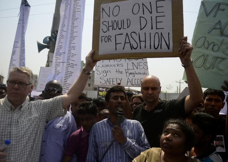 Bangladeshi activists and relatives of the victims of the Rana Plaza building collapse take part in a protest marking the first anniversary of the disaster at the site where the building once stood in Savar, on April 24, 2014