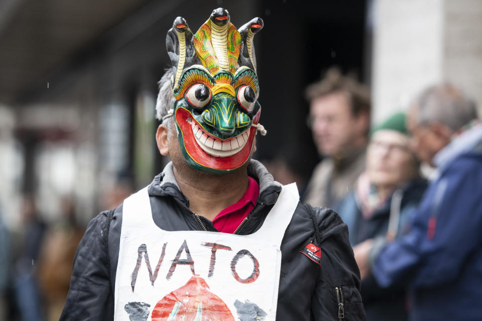 <p>A disguised protestor attends a rally to mark the International Labor Day, in Zurich, Switzerland, on May 1, 2018. (Photo: Patrick Huerlimann/Keystone via AP) </p>