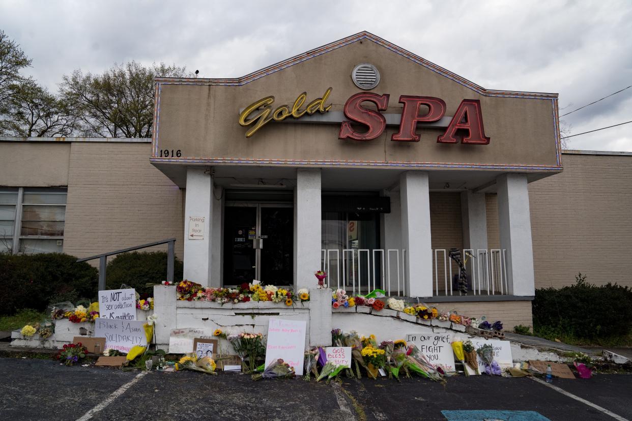 Flowers adorn Gold Spa during a demonstration against violence against women and Asians after three women were gunned down on March 18 in Atlanta. Suspect Robert Aaron Long, 21, was arrested after a series of shootings at three area spas left eight people dead, including six Asian women. 