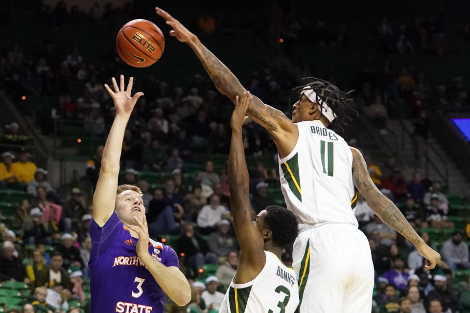 Baylor forward Jalen Bridges (11) blocks a shot against Northwestern State guard Isaac Haney (3) as Baylor guard Dale Bonner (3) reaches in during the second half of an NCAA college basketball game in Waco, Texas, Tuesday, Dec. 20, 2022. Baylor won 58-48. (AP Photo/LM Otero)