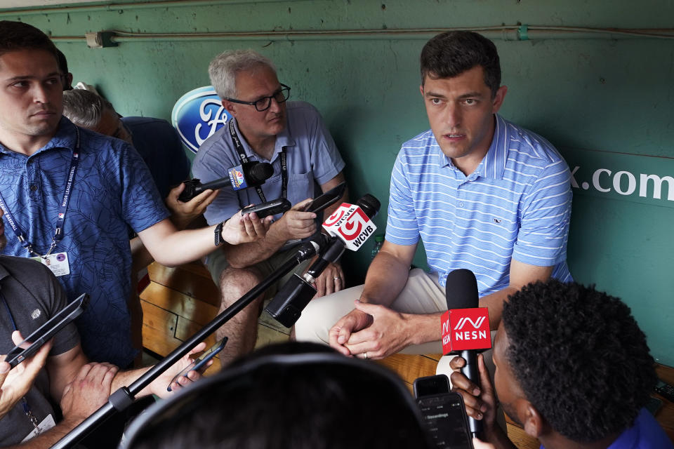 Chaim Bloom, Boston Red Sox chief baseball officer, talks with reporters in the dugout prior to a baseball game against the Cleveland Guardians at Fenway Park, Wednesday, July 27, 2022, in Boston. The Red Sox dropped into last place in the American League East Tuesday evening following a loss to the Guardians. (AP Photo/Charles Krupa)