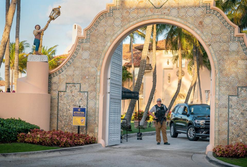A Secret Service agent stands guard at the front entrance to former President Donald Trump's Mar-a-Lago Club in Palm Beach in March 2023.