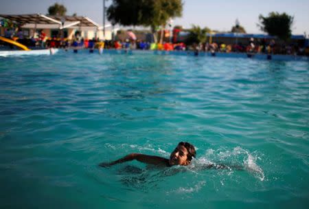 A Palestinian boy swims at Sharm Park Water City, in Gaza July 9, 2018. Picture taken July 9, 2018. REUTERS/Mohammed Salem