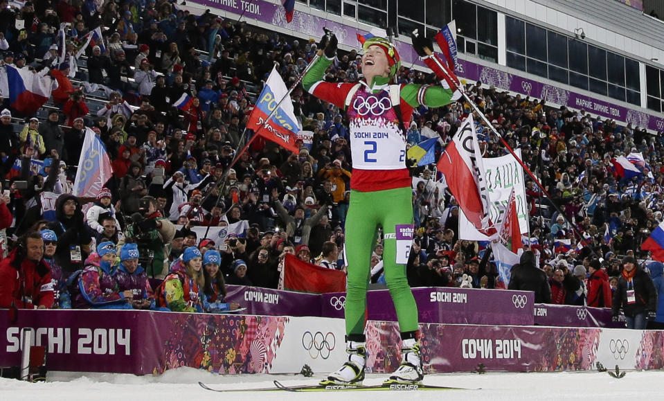 Belarus' Darya Domracheva celebrates winning the gold medal in the women's biathlon 12.5k mass-start, at the 2014 Winter Olympics, Monday, Feb. 17, 2014, in Krasnaya Polyana, Russia. (AP Photo/Felipe Dana)