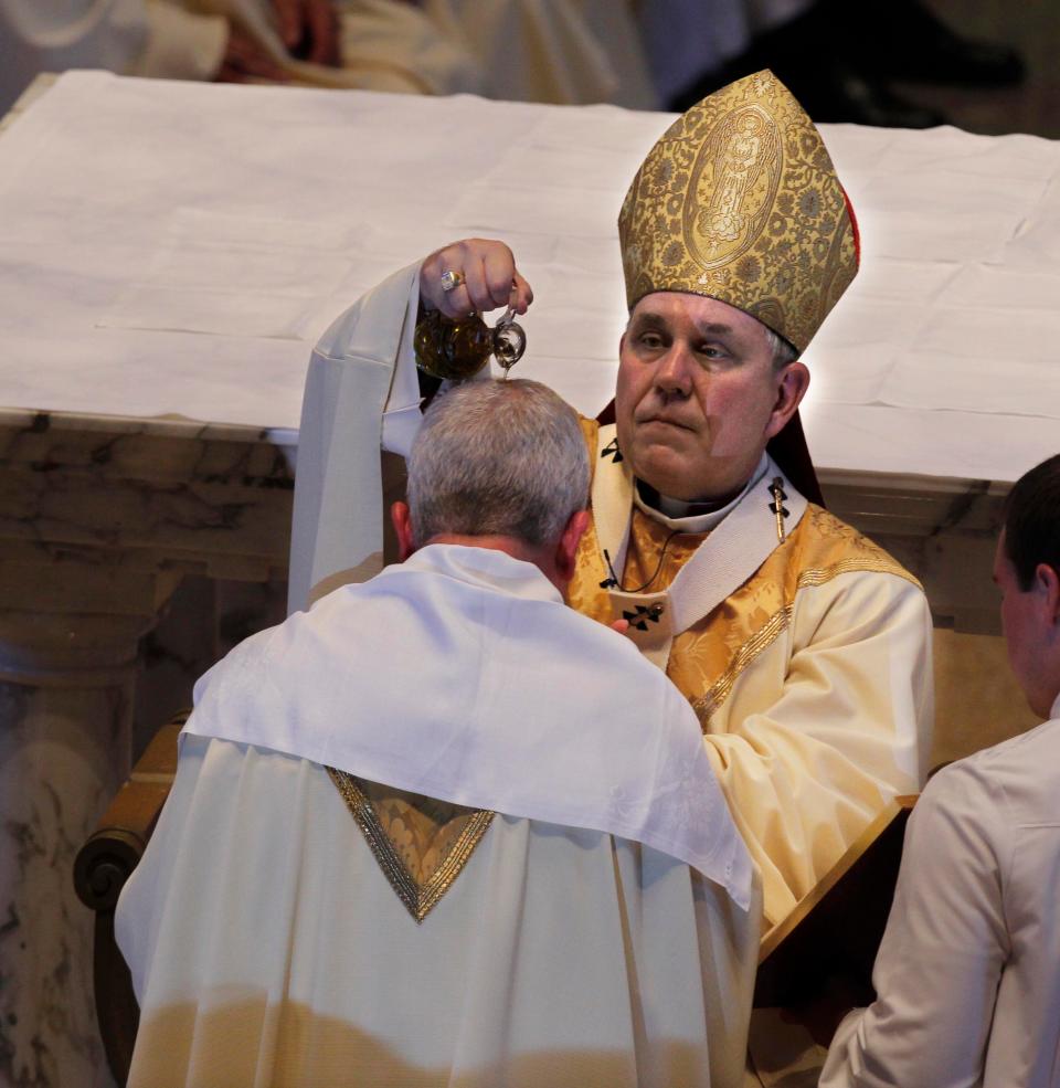 Milwaukee Archbishop Jerome Listecki pours oil over the head of Father Donald Hying at St. John's Cathedral during the ordination Mass for Bishop-elect Father Donald Hying, who became the next auxillary bishop of the archdiocese of Milwaukee on July 20, 2011.