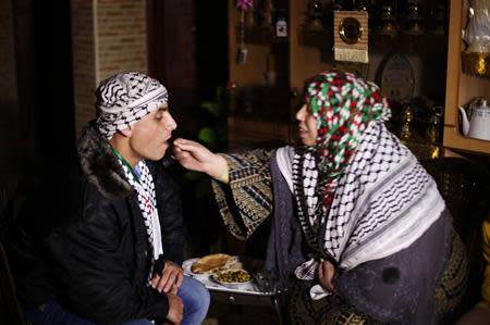 Freed Palestinian prisoner Rami Barbakh, who was held by Israel for 20 years, has his first breakfast with his mother after he was released, in Khan Younis in the southern Gaza Strip December 31, 2013. REUTERS/Ibraheem Abu Mustafa