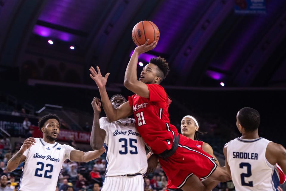 Mar 10, 2023; Atlantic City, NJ, USA; Marist Red Foxes guard Tyler Saint-Furcy (21) shoots the ball against St. Peter's Peacocks forward Mouhamed Sow (35) during the first half at Jim Whelan Boardwalk Hall. Mandatory Credit: John Jones-USA TODAY Sports