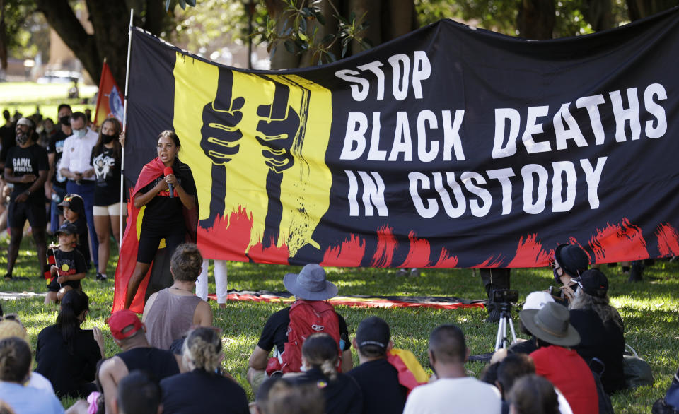 A speaker addresses a crowd during an Aboriginal-lead Invasion Day rally on Australia Day in Sydney, Tuesday, Jan. 26, 2021. Many of Australia's First Nations people say that sovereignty has never been ceded and oppose ongoing colonial violence and destruction. (AP Photo/Rick Rycroft)