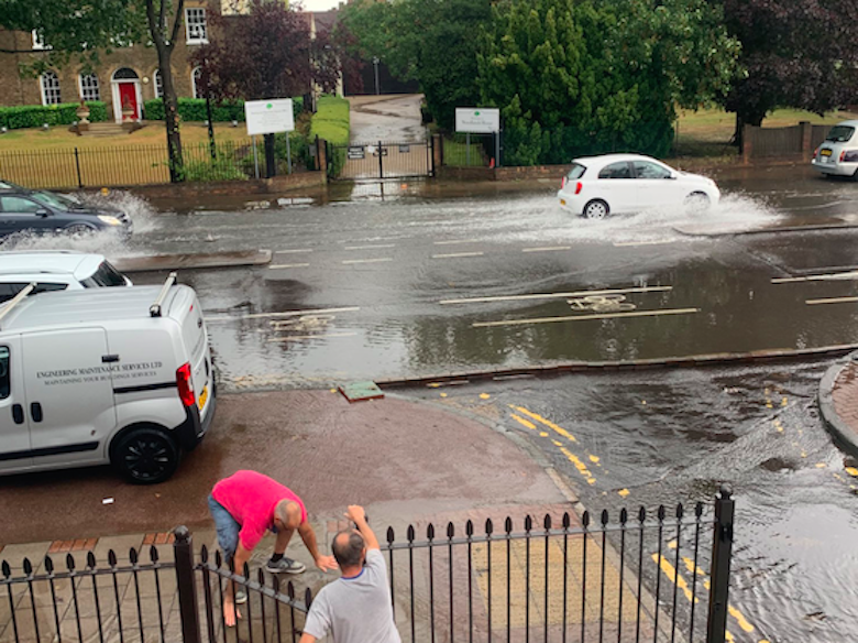 Cars struggle to get through floodwater in Dagenham, east London, on Sunday. (Lee Herwig/Twitter)