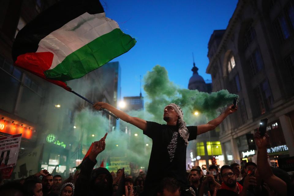 People take part in a demonstration in support of Palestine at the Israeli Embassy in London on Monday (Getty Images)