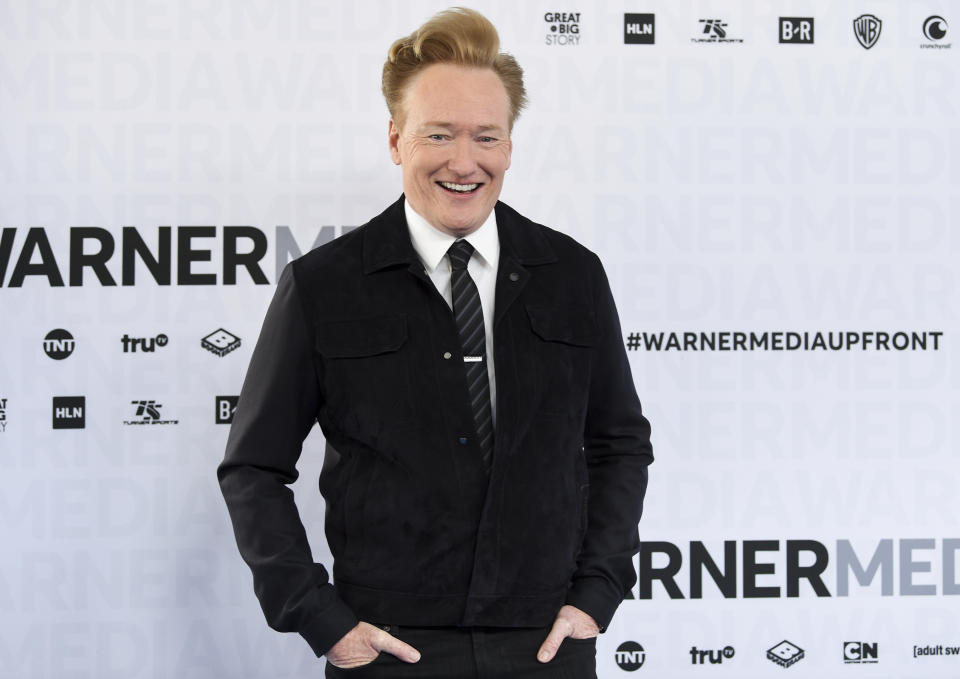 FILE - In this May 15, 2019 file photo shows late night talk show host Conan O'Brien at the WarnerMedia Upfront in New York. O'Brien said he will resume putting out new episodes of TBS' “Conan” on March 30. His staff will remain at home, and the show will be cobbled together with O'Brien on an iPhone and guests via Skype. (Photo by Evan Agostini/Invision/AP, File)