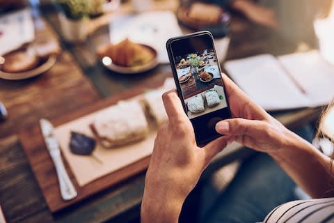 "You only have to look at the families in hotel restaurants where every member is swiping and prodding their phones to realise where the dark path to total digital addiction lies" - Credit: GETTY
