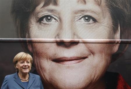 German Chancellor Angela Merkel and leader of the Christian Democratic Union party CDU stands in front of her election campaign tour bus before a CDU board meeting in Berlin September 16, 2013. REUTERS/Fabrizio Bensch