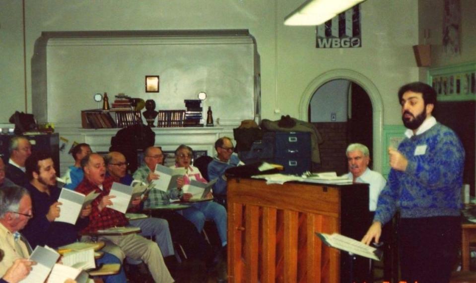 Orpheus director John Palatucci, right, conducts a rehearsal of the men's chorus in 1991.