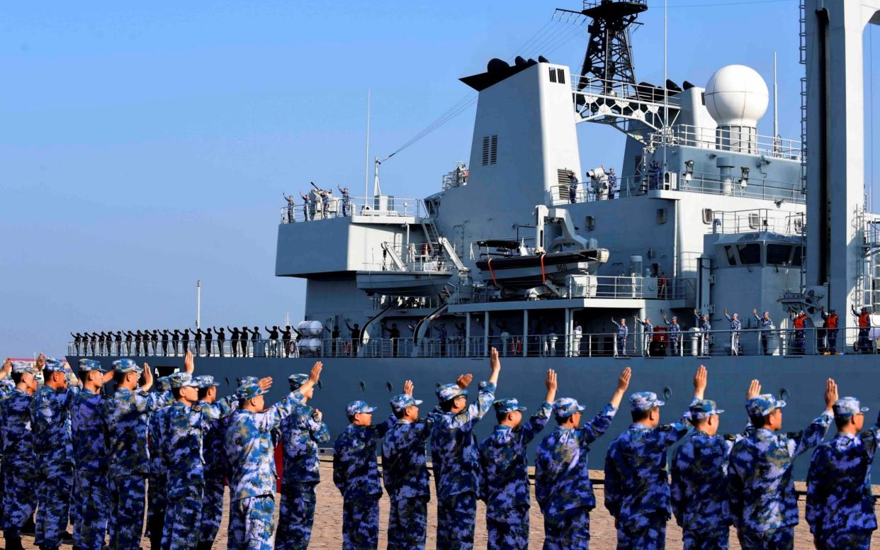 Soldiers of the Chinese People's Liberation Army (PLA) Navy take part in a ceremony - CHINA DAILY