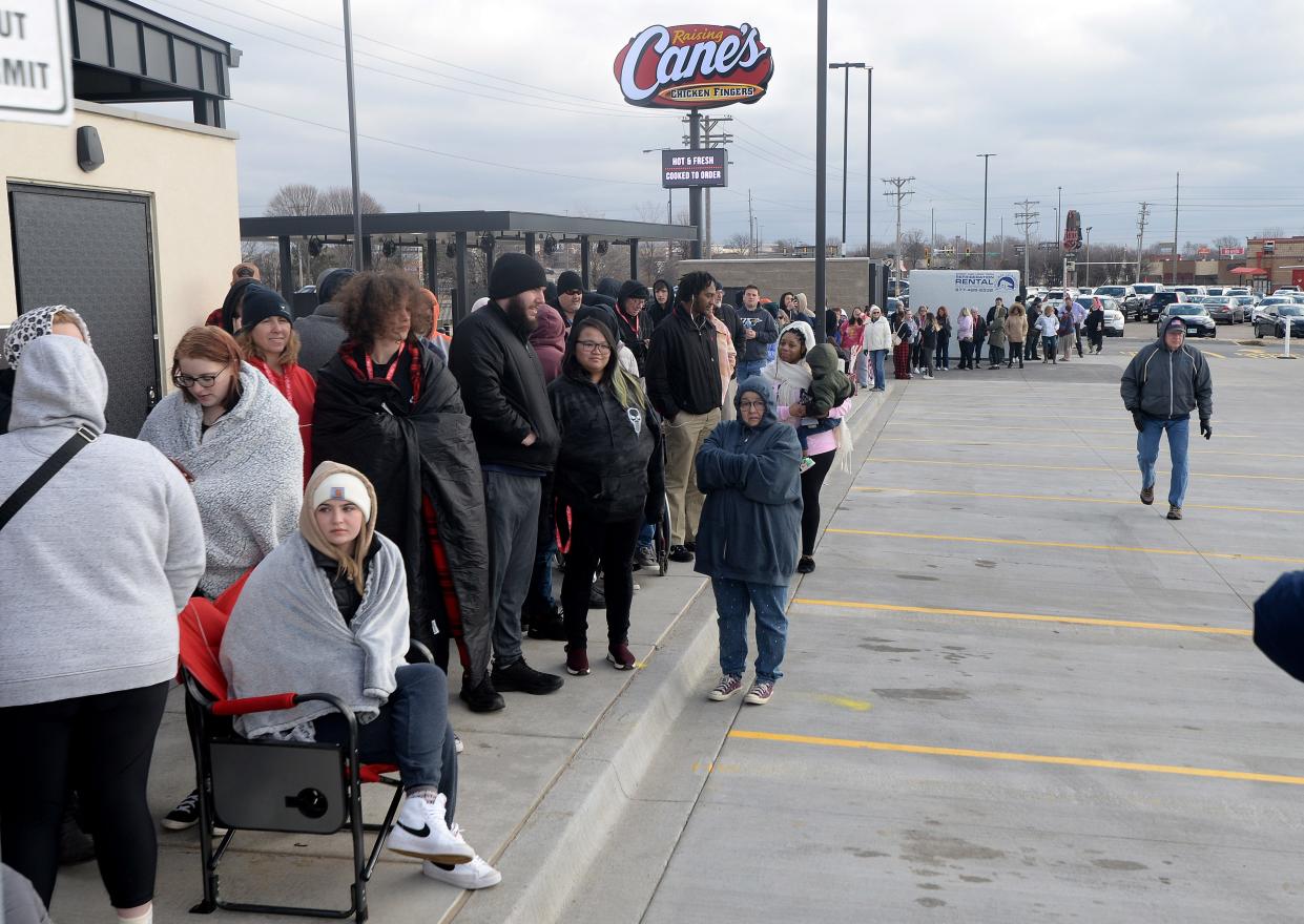 The line grows outside the new Raising Cane's restaurant in Springfield as it gets closer to opening time Tuesday, March 7, 2023.