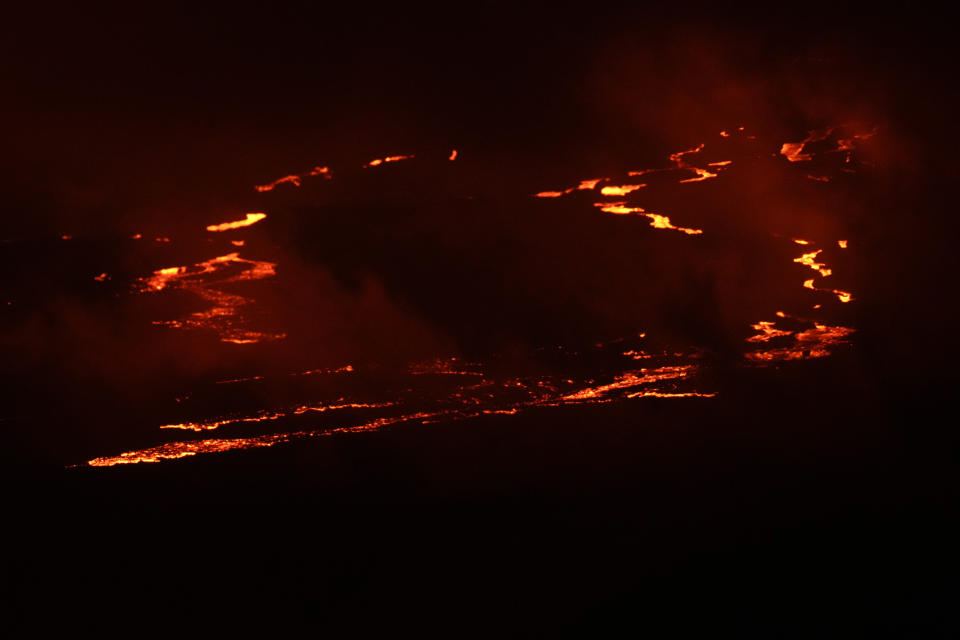 Lava flows as the Mauna Loa volcano erupts Saturday, Dec. 3, 2022, near Hilo, Hawaii. (AP Photo/Gregory Bull)