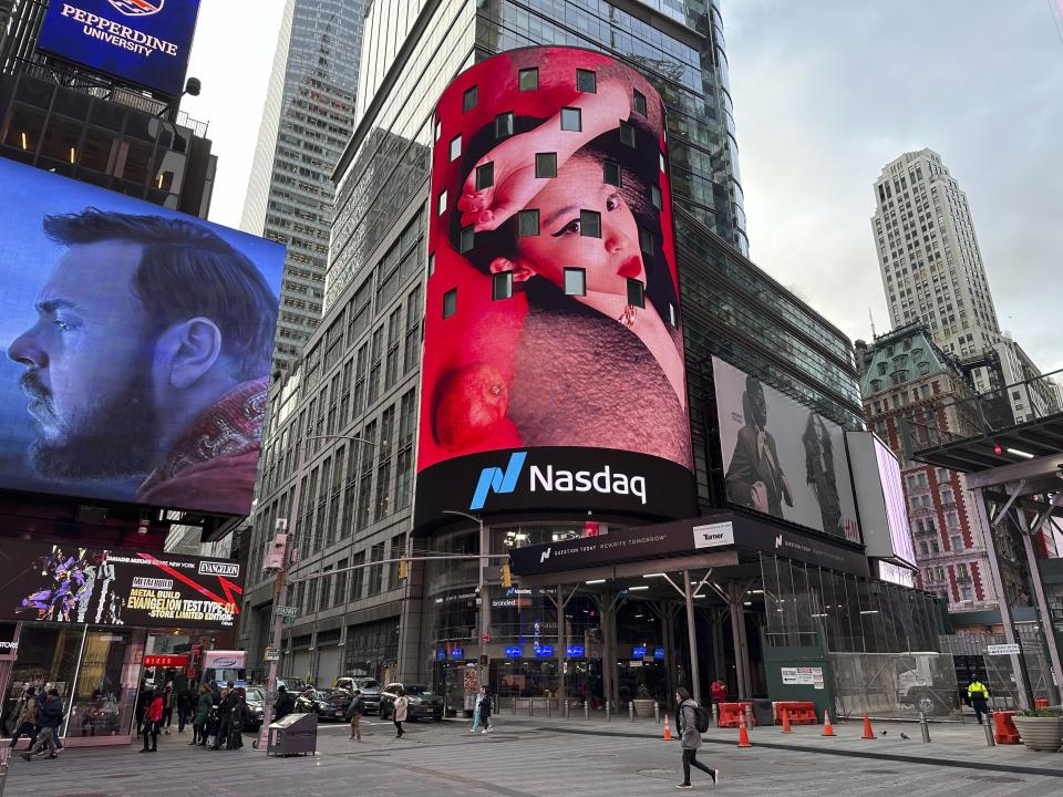 Pedestrians walk past the Nasdaq building in New York on Tuesday, March 26, 2024. Donald Trump’s social media company begins trading publicly Tuesday. Trump Media & Technology Group Corp. was acquired Monday by a blank-check company called Digital World Acquisition Corp. Trump Media, which runs the social media platform Truth Social, now takes Digital World’s place on the Nasdaq stock exchange. (AP Photo/Peter Morgan)