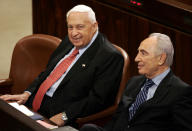 <p>Israeli Prime Minister Ariel Sharon, left, and his Deputy Premier Shimon Peres, right, pause during a session in the Knesset, Israel’s parliament in Jerusalem, Wednesday Feb. 16, 2005. (AP Photo/Lefteris Pitarakis) </p>