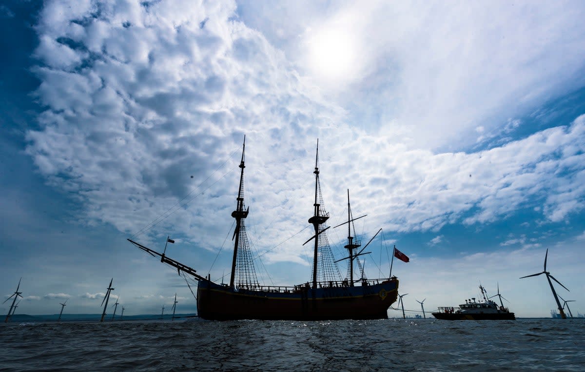 HM Bark Endeavour, a full-scale replica of Captain Cook’s ship, is pulled by a tugboat from Middlesbrough to its permanent home in Whitby  (PA Archive)