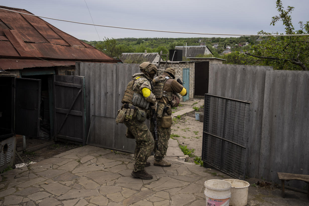 Ukrainian National Guard soldiers take positions during a reconnaissance mission in a recently retaken village on the outskirts of Kharkiv, east Ukraine, Saturday, May 14, 2022. (AP Photo/Bernat Armangue)