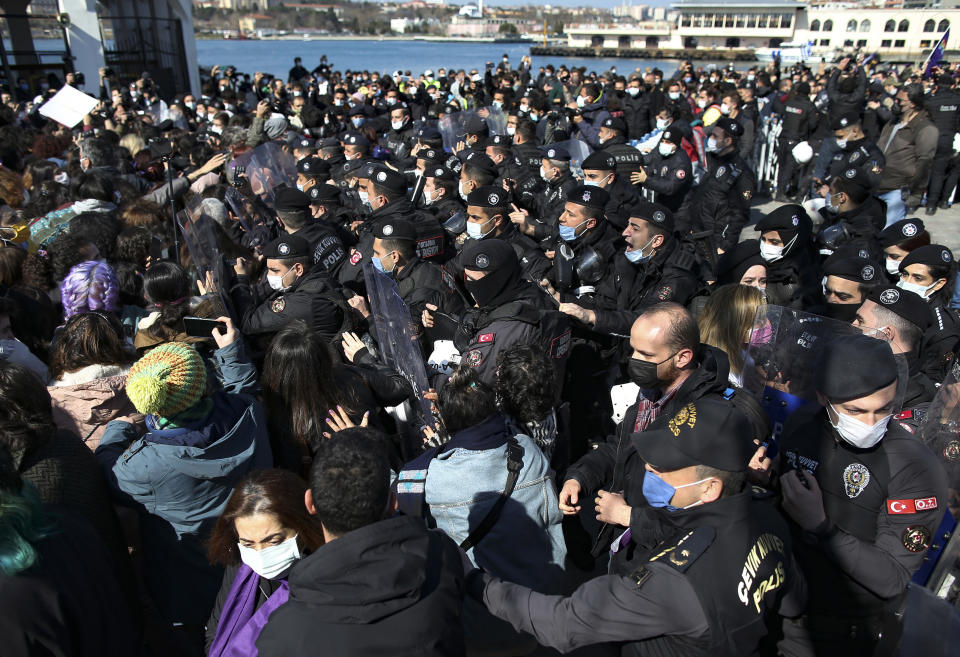 Turkish police officers, right, scuffle with protesters during a demonstration in Istanbul, Saturday, March 27, 2021, against Turkey's withdrawal from Istanbul Convention, an international accord designed to protect women from violence. The Istanbul Convention states that men and women have equal rights and obliges national authorities to take steps to prevent gender-based violence against women, to protect victims and to prosecute perpetrators. Conservative groups and some officials from Turkeys President Recep Tayyip Erdogan's Islamic-oriented ruling party take issue with these terms, saying they promote homosexuality. (AP Photo/Emrah Gurel)