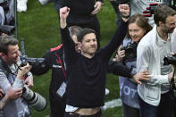 Leverkusen's head coach Xabi Alonso, center, celebrates winning the German championship after the Bundesliga soccer match between Bayer Leverkusen and Werder Bremen at the BayArena in Leverkusen, Germany, Sunday April 14, 2024. (David Inderlied/dpa via AP)