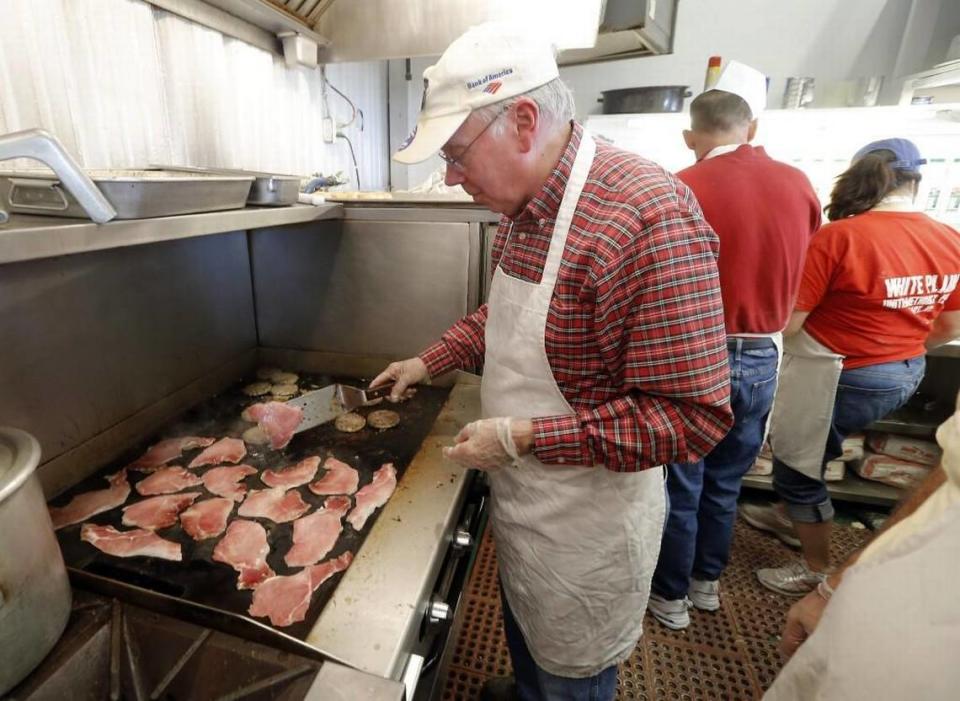 The Cary First United Methodist Church has been a vendor at the N.C. State Fair since 1916. Pictured here at the fair in 2015, Walt Wheeler cooks up the ham for the ham biscuits made and sold by church volunteers.