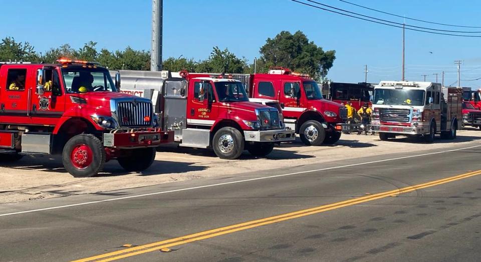 Fire crews from both Stanislaus and San Joaquin counties, assisted by Cal Fire and other agencies, battle a vegetation fire on both sides of McHenry Avenue near the Stanislaus River on Monday, July 3, 2023.