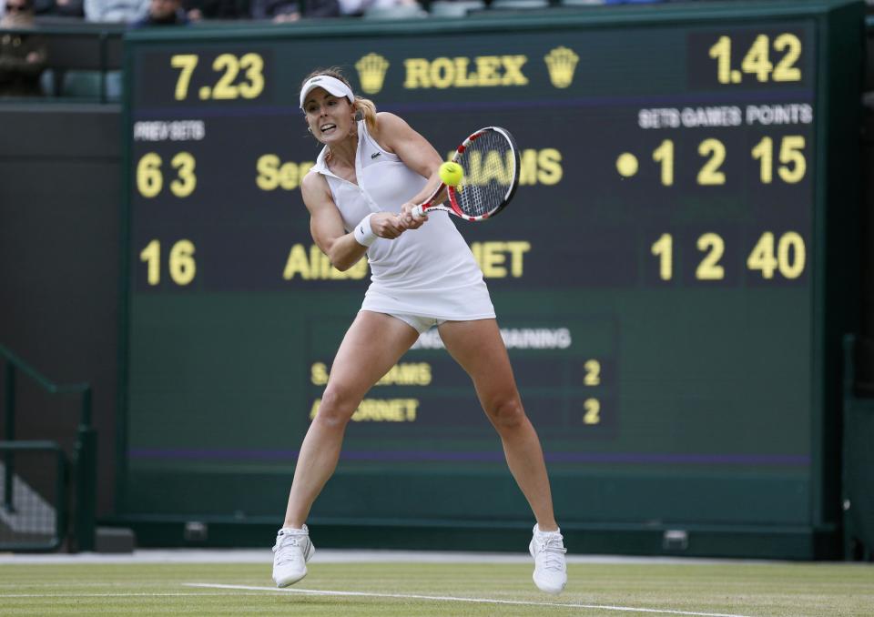 Alize Cornet of France hits a return during her women's singles tennis match against Serena Williams of the U.S. at the Wimbledon Tennis Championships, in London June 28, 2014. REUTERS/Stefan Wermuth (BRITAIN - Tags: SPORT TENNIS)