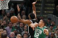 Boston Celtics' Grant Williams (12) blocks a shot by Brooklyn Nets' Bruce Brown (1) during the first half of Game 2 of an NBA basketball first-round playoff series Wednesday, April 20, 2022, in Boston. (AP Photo/Michael Dwyer)