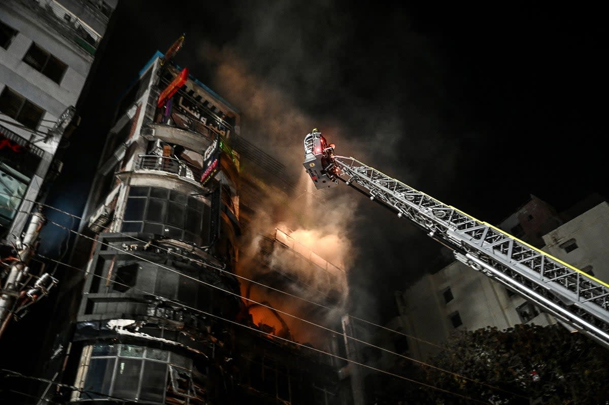 Firefighters work to extinguish a fire in a commercial building that killed at least 43 people (AFP via Getty Images)