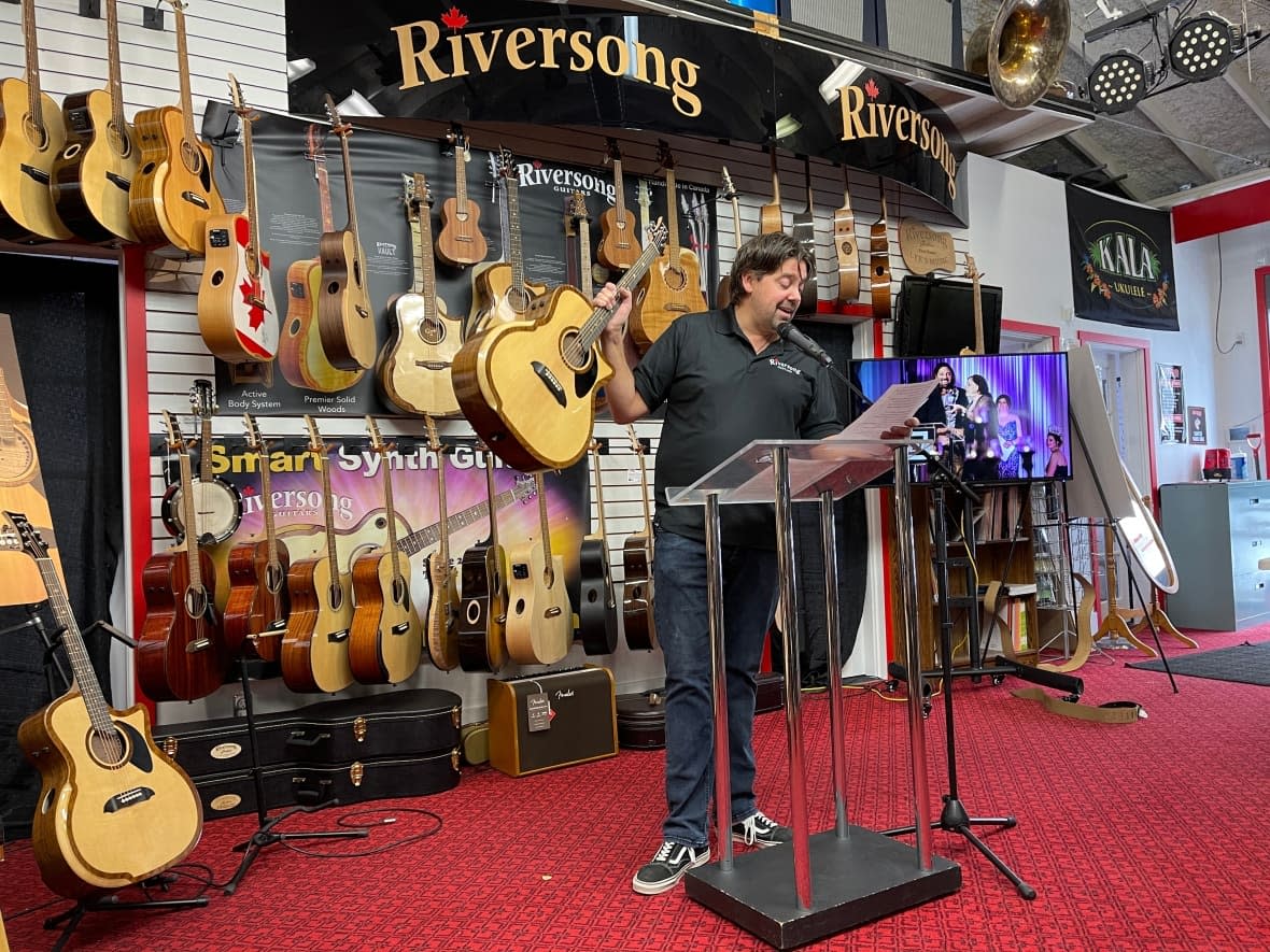 Mike Miltimore, owner of Riversong Guitars in Kamloops, B.C., speaks on Monday, Dec. 5, about winning a Musical Merchandise Review Dealers’ Choice Award for acoustic guitar of the year. (Marcella Bernardo/CBC - image credit)