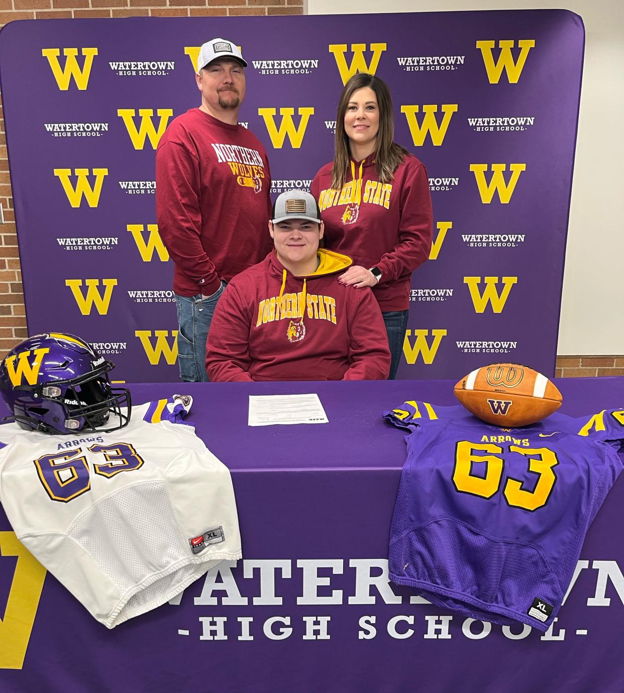 Watertown High School senior Jarrett Theisen signed to play college football at Northern State University in Aberdeen on Wednesday. He is pictured with his father Kevin and mother Joanie.