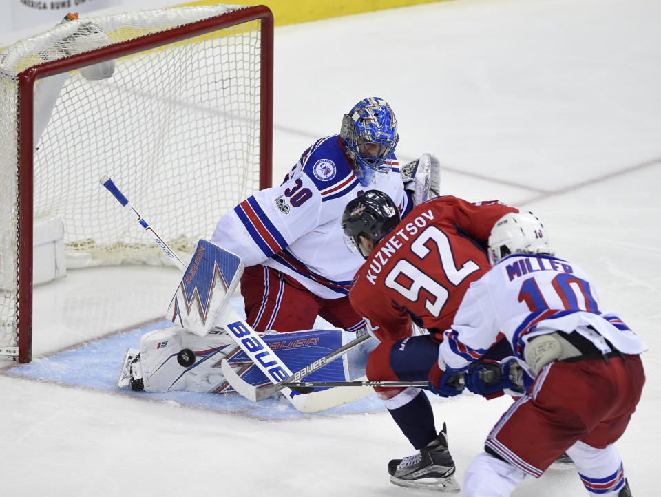 Washington Capitals center Evgeny Kuznetsov (92), of Russia, shoots the puck for a goal past New York Rangers goalie Henrik Lundqvist (30), of Sweden, as left wing J.T. Miller (10) defends during the third period of an NHL hockey game, Wednesday, April 5, 2017, in Washington. The Capitals won 2-0. (AP Photo/Nick Wass)