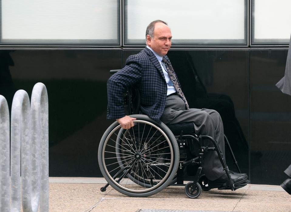 Developer Robert Morgan leaves federal court in Buffalo with his attorneys after being charged with fraud 