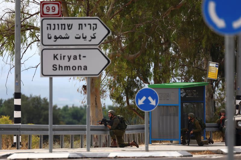 FILE PHOTO: Israeli soldiers kneel in position, as tension mounts between the Lebanon and Israel, in northern Israel