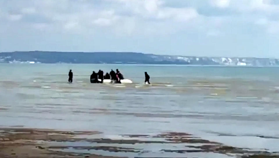 Migrants filmed coming ashore on Greatstone beach in Littlestone, Kent (Picture: SWNS)