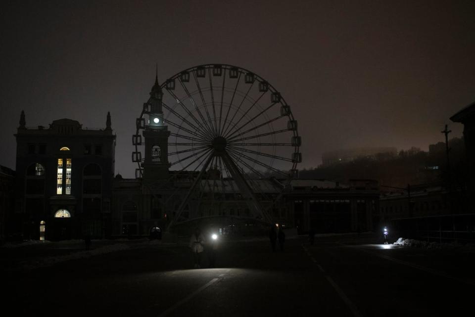 A view of Podil district during a blackout after a Russian rocket attack in Kyiv, Ukraine, Wednesday, Nov. 23, 2022. Russia unleashed a new missile onslaught on Ukraine's battered energy grid Wednesday, robbing cities of power and some of water and public transport, too, compounding the hardship of winter for millions. The aerial mauling of power supplies also took nuclear plants and internet links offline and spilled blackouts into neighbor Moldova.