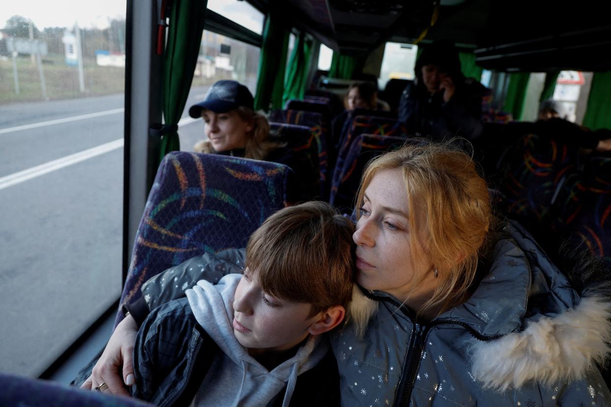 Alla Yatsentiuk embraces her 14-year-old son Danylo, who went to a Russian-organised summer camp from non-government controlled territories and was then taken to Russia, after returning via the Ukraine-Belarus border, in Volyn (Reuters)