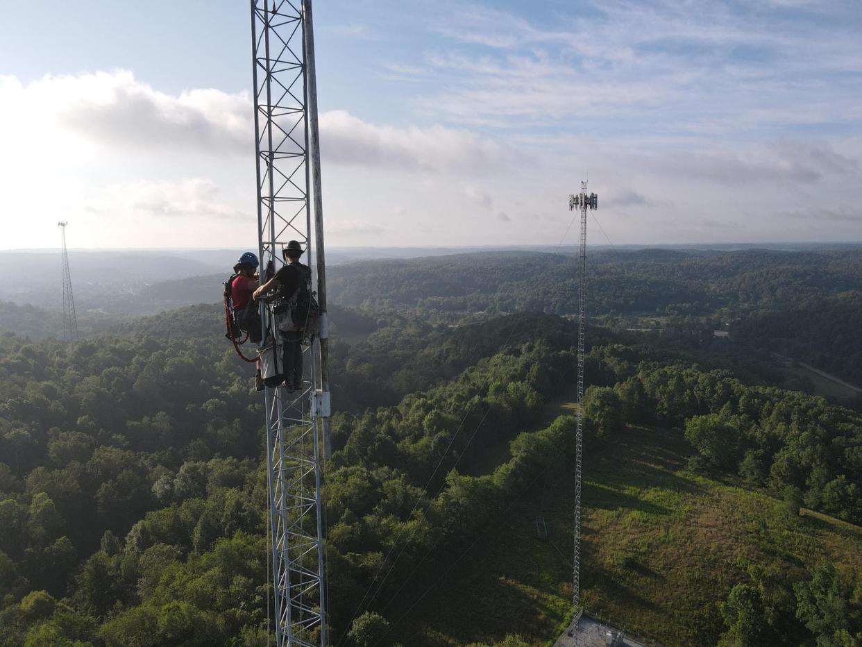 Employees of Smart Way Communications work on a wireless internet tower outside of Uhrichsville.