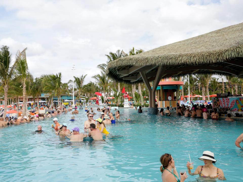 people with drinks at the pool in Royal Caribbean Perfect Day at CocoCay's Hideaway Beach