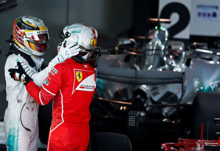 Formula One - F1 - Australian Grand Prix - Melbourne, Australia - 26/03/2017 - Ferrari driver Sebastian Vettel of Germany is congratulated by Mercedes driver Lewis Hamilton of Britain after winning the Australian Grand Prix. REUTERS/Brandon Malone