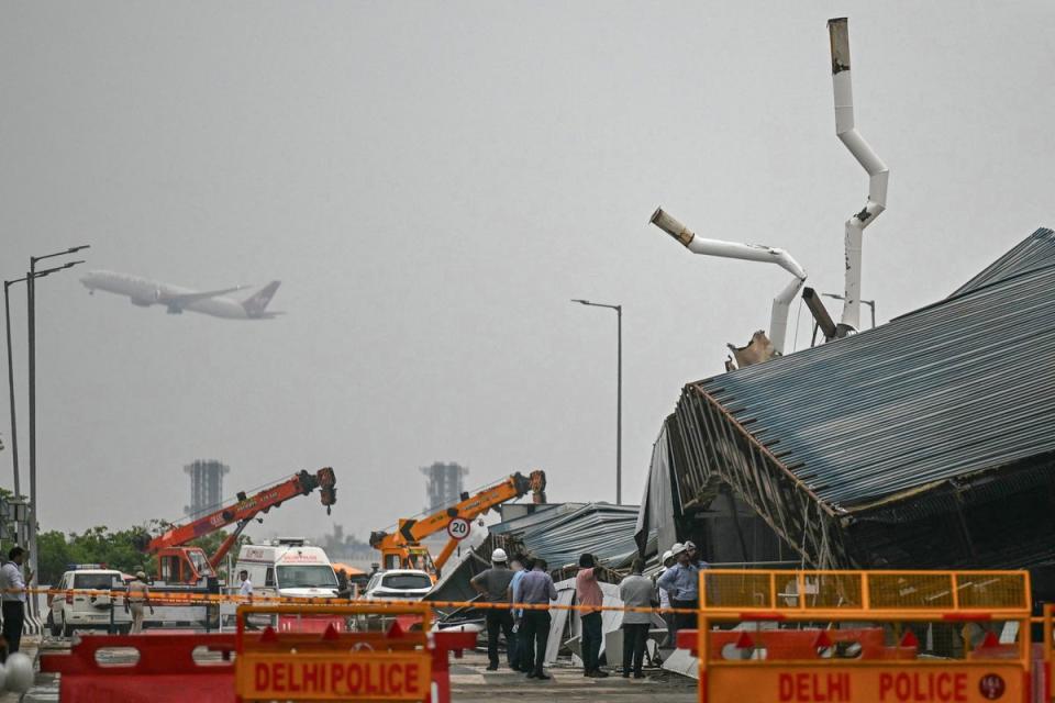 Rescuers work at the collapsed terminal roof of New Delhi's international airport (AFP via Getty Images)