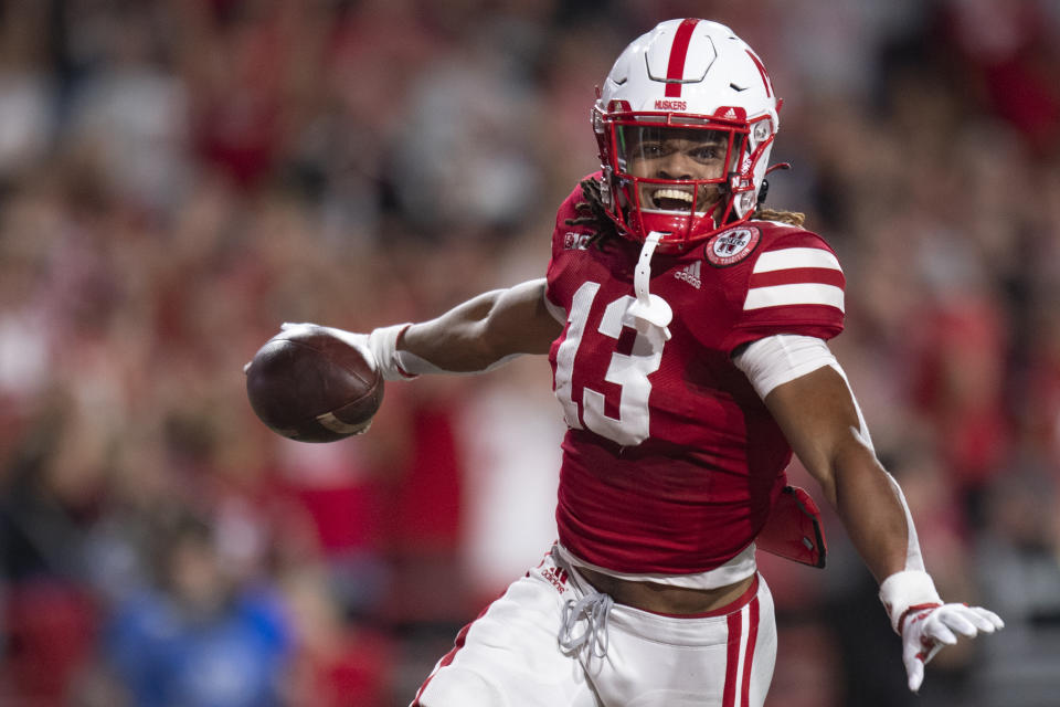 Nebraska defensive back Malcolm Hartzog (13) celebrates after converting a blocked kick into a touchdown in the 2nd quarter during an NCAA football a game between Nebraska and Indiana, Saturday, Oct. 1, 2022 at Memorial Stadium in Lincoln, Neb. (Noah Riffe/Lincoln Journal Star via AP)