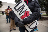 <p>A striking teacher hold a “United” signs= during a rally outside the West Virginia Capitol in Charleston, W.Va., on Friday, March 2, 2018. (Photo: Scott Heins/Bloomberg via Getty Images) </p>